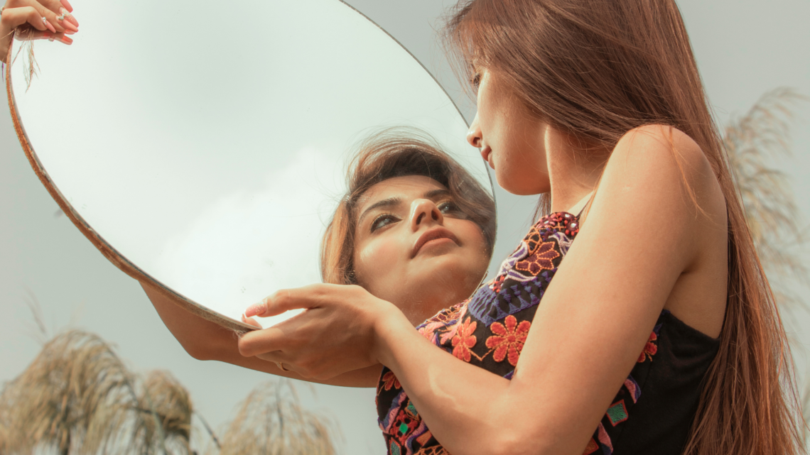 woman looking in the mirror