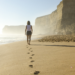 woman walking barefoot at the beach